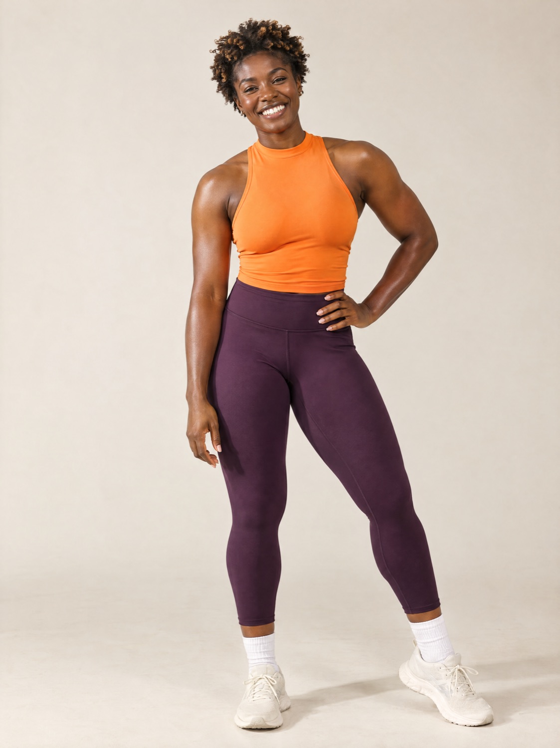 An illustrative Gauge AI character in an orange training top, smiling in a relaxed stance.